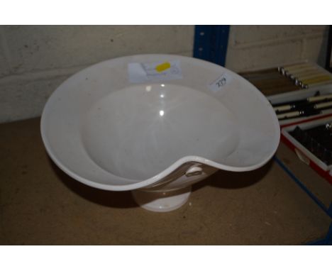 A white glazed ceramic pedestal bowl