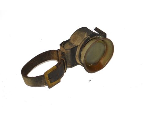 An early possibly wrist worn cycle lamp