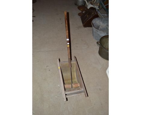 A vintage sieve with long handled roller