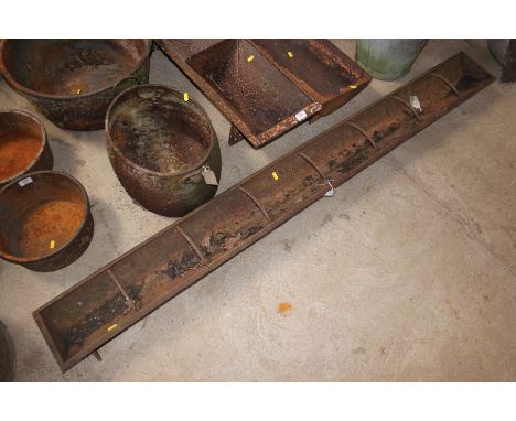 A long metal cast iron trough