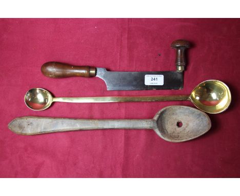 A herb cutter; brass ladle and a wooden spoon