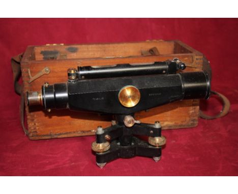 A Reynolds Dumpy Level with an associated wooden tripod and measuring staff