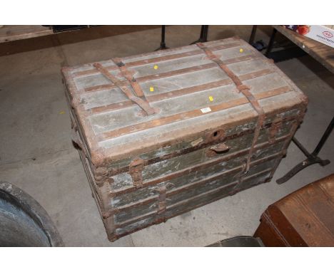 A large wooden and metal bound travelling trunk