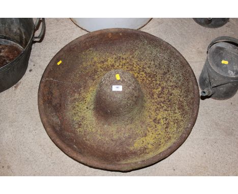 A cast iron circular pig trough 