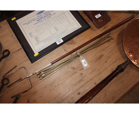 A brass cat (portable stand) and a large long handled toasting fork