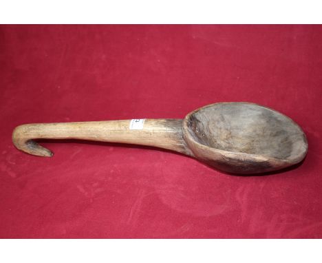 A large wooden ladle