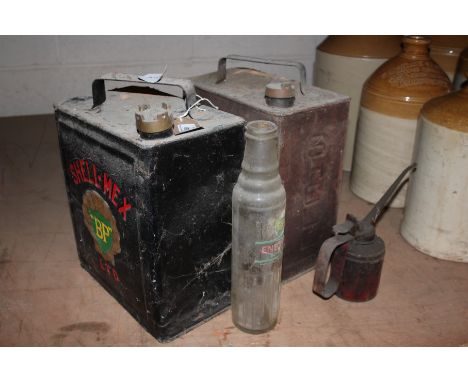 A BP Shell Mex fuel can; a Shell Motor Spirit can; a vintage oil can and a glass BP Energol oil bottle