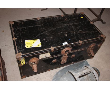 A black metal travelling trunk