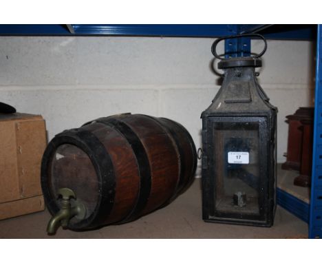 A metal lantern and a small oak barrel with brass tap