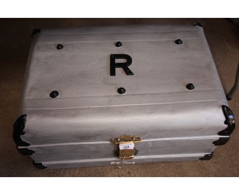 A metal trunk with brass lock and key 