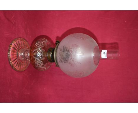 A Victorian glass oil lamp with decorative shade 