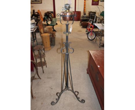A wrought iron and copper and brass standard oil lamp 