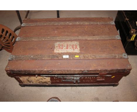 A large metal and wooden bound travelling trunk