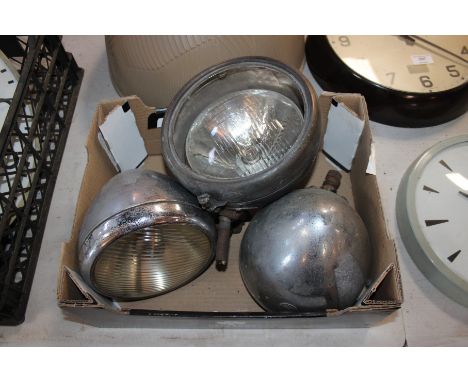 Two Vauxhall chrome car head lights and a "King Of The Road" car headlight