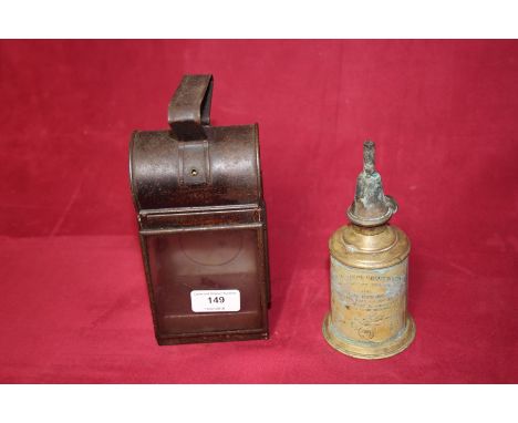 An antique French pigeon oil lamp and a small hand held lamp