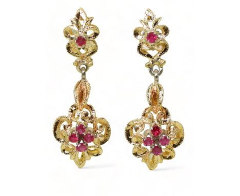 A PAIR OF CANADIAN RUBY EARRINGS the pretty scroll mount is made in yellow and white metal and set with five round cut rubies