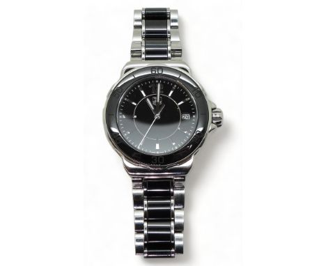 A TAG HEUER FORMULA 1 the body and strap in stainless steel with black ceramic bezel and strap links, silver coloured baton n