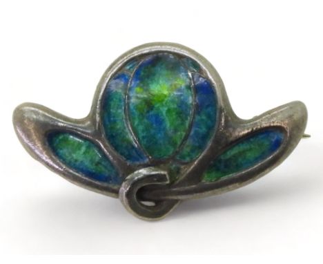 A CYMRIC BROOCH enamelled in peacock colours, to the Art Nouveau design signed 'Cymric' with Liberty & Co hallmarks L&Co stam