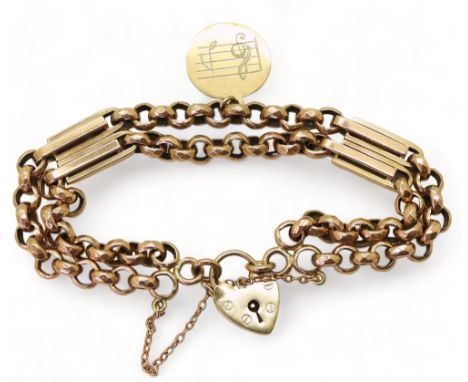 A VINTAGE BRACELET with facet cut round links and double baton links a heart shaped clasp and medallion engraved with a trebl