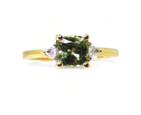 AN APATITE AND DIAMOND RING set with a cushion cut pale green apatite, approx 6mm x 6mm, with two trilliant cut diamonds set 