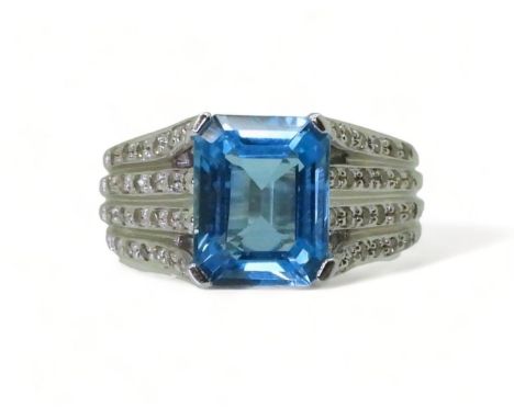 A BLUE TOPAZ &amp; DIAMOND RING made by the jewellery channel in 14k white gold, the step cut blue topaz is 9.9mm x 7.9mm wit