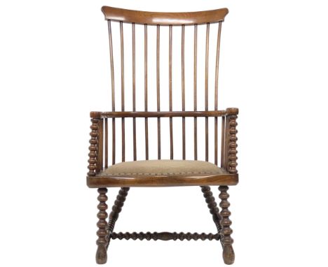 A 19TH CENTURY STAINED ELM DARVEL CHAIR ATTRIBUTED TO JOHN MC MATH  with comb back over hoop arms with bobbin front support o