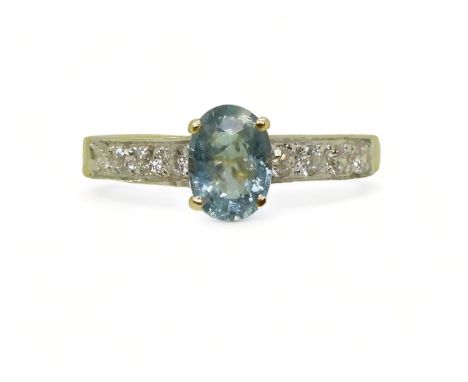 AN 18CT GOLD AQUAMARINE AND DIAMOND RING set with an oval cut aquamarine, with four pave set brilliant cut diamonds set to th