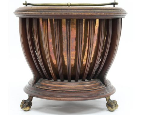 A 19TH CENTURY REGENCY STYLE COPPER COAL BUCKET&nbsp; with brass swing handle within circular stand with open stile sides on 