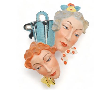 A  CZECHOSLOVAKIAN ART DECO DOUBLE HEAD WALL MASK with vase pocket, incised number 15787, 31cm high Condition Report:some pai