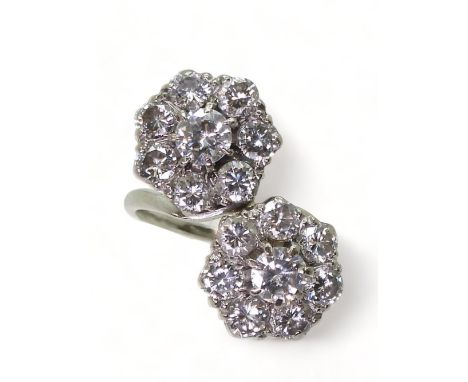 A DIAMOND DOUBLE FLOWER RING mounted in white metal and set with estimated approx 2.50cts in total., Finger size M1/2,diamete