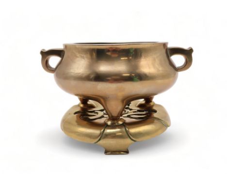 A CHINESE BRASS CENSER AND STAND The bulbous body cast with scroll handles and on tripod legs, seal mark, 21.5cm wide and the