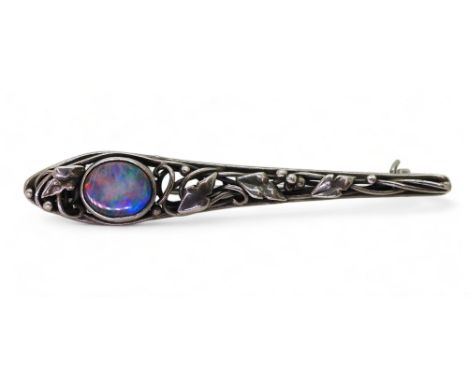 AN ART &amp; CRAFTS BROOCH possibly by Rhoda Wager circa 1920's. the white metal bar brooch with leaf vine and berry design i