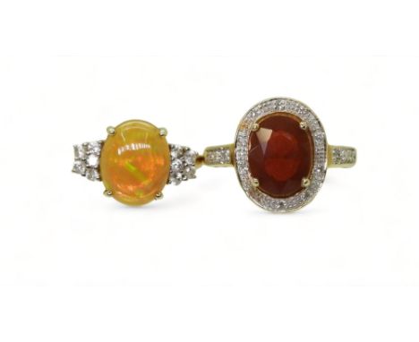 TWO OPAL RINGS a 9ct gold welo opal ring with white zircon shoulders, opal approx 11mm x 9mm, finger size M, a 9ct gold fire 