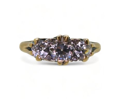 A SCROLL MOUNTED DIAMOND RING the bright yellow mount set with three old cut diamonds, with an estimated approx diamond total