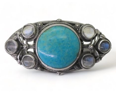 AN ARTS &amp; CRAFTS BROOCH made by Edmund Thomas Wyatt Ware (1883-1960) the white metal brooch is set with a Ruskin ceramic 