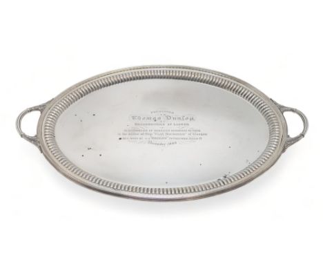 A VICTORIAN SILVER TWIN-HANDLED SERVING TRAY by Barnard Brothers, London 1895, of oval form, with acanthus leaf handles and a