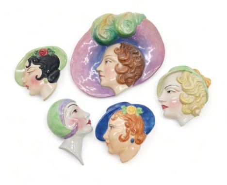 A COLLECTION OF ART DECO POTTERY WALL MASKS each modelled as a woman's head, many by C Ltd including  model numbers 6, 20, 22