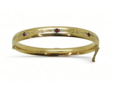 RUBY AND DIAMOND BANGLE mounted in heavy gauge solid 9ct gold, grain set with six diamonds with an estimated combined total o