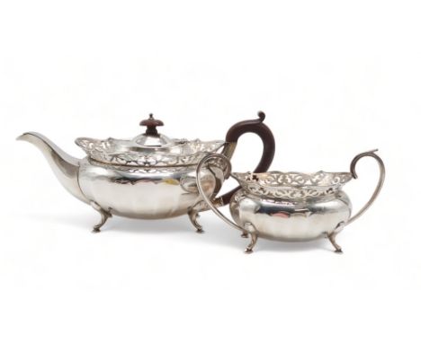 A GEORGE V SILVER PART TEA SERVICE by William Adam, Birmingham 1930, of faceted oval form, with applied barbed openwork rims,