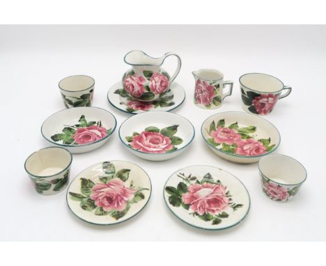 A COLLECTION OF WEMYSS WARE all painted with cabbage roses, including a cup and saucer, two other saucers, a plate 17.5cm dia