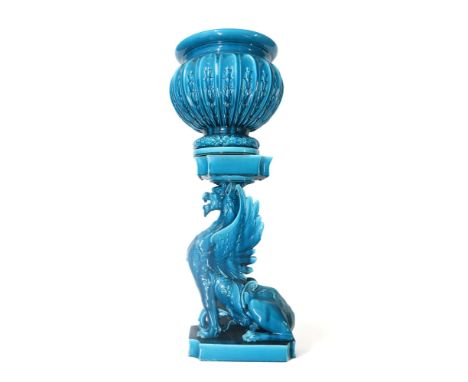 A BURMANTOFTS STYLE JARDINIERE AND STAND the base modelled as a Griffin seated on a plinth, the bowl with laurel wreath base 