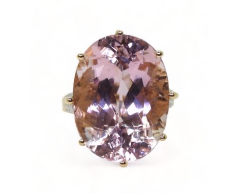 A KUNZITE STATEMENT RING measuring 20mm x 15mm x 11mm, in 14k gold multi claw basket setting, with diamond accents to the sho