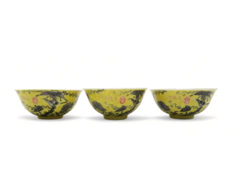 THREE CHINESE YELLOW GROUND BOWLS Painted with birds amongst scattered flowers and tendrils, gilt seal and inscription, four 