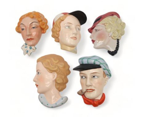 A COLLECTION OF CZECHOSLOVAKIAN AND OTHER ART DECO WALL MASKS one of a man in a cap smoking a pipe, the others of girls' head