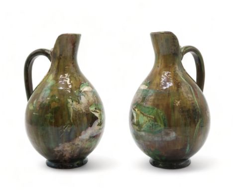 A PAIR OF FRENCH POTTERY EWERS each painted with two frogs on naturalistic ground, each signed to the side K Schueller and wi