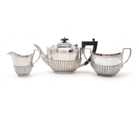 A GEORGE V THREE PIECE SILVER TEA SERVICE by Martin Hall &amp; Co, Birmingham 19198, in the Queen Anne style, the bodies part