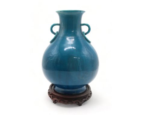 A TURQUOISE MONOCHROME HARD PASTE PORCELAIN VASE of Chinese Hu shape, with ring handles and all over crackle glaze, 36cm high