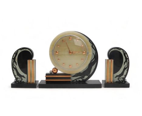AN ART DECO STYLE CLOCK GARNITURE the clock with onyx face on a slate ground with etched detail of a running dog, the pair of
