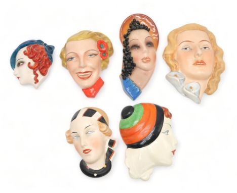 A COLLECTION OF CZECHOSLOVAKIAN ART DECO WALL MASKS all of girls' heads, including a Royal Dux example of a girl in a head sc