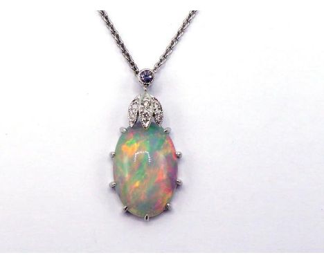 An opal and diamond pendant, the oval cabochon opal 14 x 8mm, with a pave set top, mounted in white metal, the chain marked '